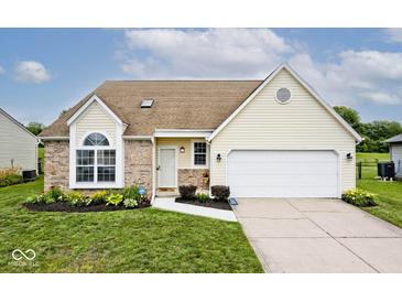 Charming single-Gathering home featuring a well-manicured lawn and a two-car garage at 11320 Lynchburg Way, Indianapolis, IN 46229