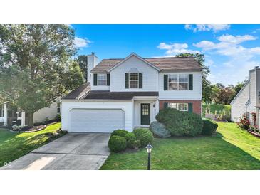 Charming two-story home featuring a well-manicured lawn and an attached two-car garage at 11961 Driftstone Dr, Fishers, IN 46037