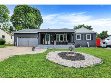 Charming one-story home with a grey exterior, covered porch and landscaped front yard at 121 Ursal Ln, Greenwood, IN 46143