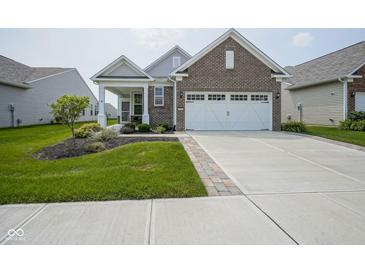 Charming single-story home with brick accents, manicured lawn, and a two-car garage at 13448 Mosaic St, Fishers, IN 46037