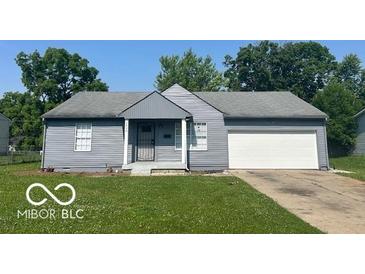 Charming single-story home with a gray exterior, attached garage, and well-maintained front lawn at 2930 N Rural St, Indianapolis, IN 46218
