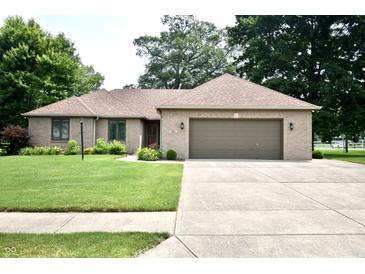 Charming brick home with a well-maintained lawn and inviting curb appeal in a tranquil neighborhood at 5943 Red Maple Dr, Indianapolis, IN 46237