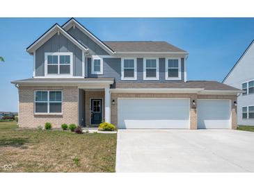 Charming two-story home with a three-car garage and well-maintained front yard at 7510 Hillway Dr, Camby, IN 46113