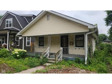 Charming single-Gathering home featuring a cozy front porch and small yard at 2157 Sugar Grove Ave, Indianapolis, IN 46202