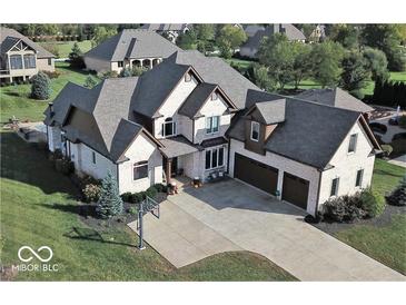 Stunning two-story home boasts a brick facade, three-car garage, and a spacious driveway with a basketball hoop at 4931 Kerrington Blvd, Bargersville, IN 46106
