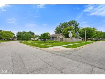 Charming single-story home with a well-maintained lawn and mature trees in a quiet neighborhood at 50 Crestview Dr, Greenwood, IN 46143