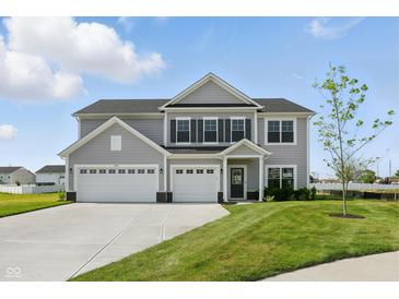 Beautiful two-story home featuring a three-car garage and well-manicured lawn in a suburban neighborhood at 5763 Greenbrier Ct, Brownsburg, IN 46112