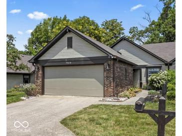 Charming home featuring a two-car garage, beautiful brick accents, and a well-maintained lawn at 7616 Derrek Pl, Indianapolis, IN 46219