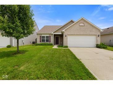 Charming single-story home featuring a well-manicured lawn and attached two-car garage at 7715 Bolero Dr, Camby, IN 46113