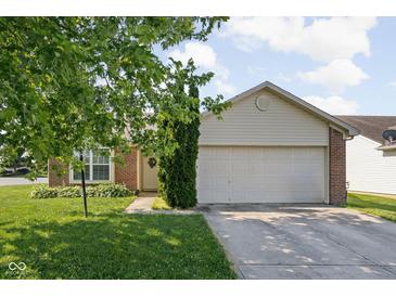 Charming single-story home featuring a two-car garage, front yard and brick accents at 779 Alvey Ct, Greenwood, IN 46143