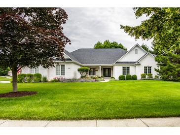 Charming brick home with a lush green lawn and mature trees, providing great curb appeal at 9678 Winter Way, Zionsville, IN 46077