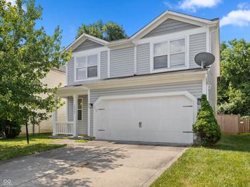 Charming two-story home with a two car garage and landscaped front yard in a residential community at 10427 Apple Creek Dr, Indianapolis, IN 46235