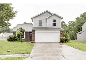 Charming two-story home with a brick and vinyl facade, a two-car garage, and a well-maintained front yard at 5234 Melbourne Rd, Indianapolis, IN 46228