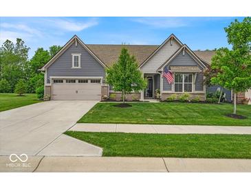 Beautifully landscaped front yard with lush green grass leading up to a modern blue home at 6536 Apperson Dr, Noblesville, IN 46060