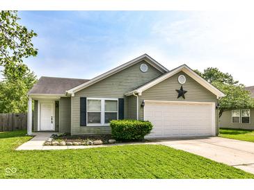 Charming single-story home with a well-manicured lawn and two car garage, perfect for suburban living at 7639 Foxglove Ln, Noblesville, IN 46062