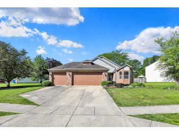 Charming two-story home with a well-maintained front yard, three-car garage, and inviting curb appeal at 9055 Glass Chimney Ln, Fishers, IN 46037