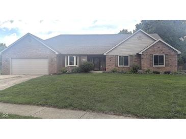 Charming single-story brick home featuring an attached two-car garage and a well-maintained front yard at 920 Corey Ln, Plainfield, IN 46168