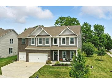 Charming two-story home with a well-manicured lawn and attached two-car garage in a lovely neighborhood at 10113 Gallop Ln, Fishers, IN 46040