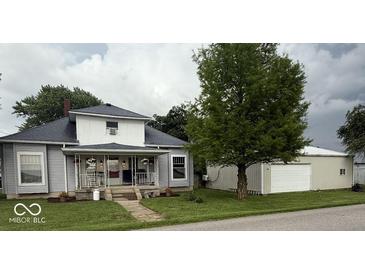Charming two-story home with a covered front porch and a detached garage at 1352 S County Road 850 W, Greensburg, IN 47240