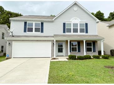 Charming two-story home with light blue siding, brick accents, and a well-manicured lawn at 3314 Montgomery Dr, Indianapolis, IN 46227
