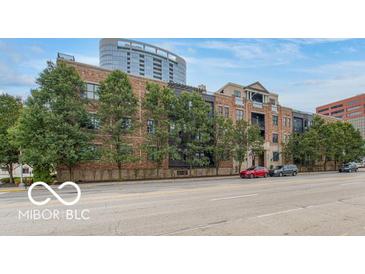 Attractive brick building with black trim, mature trees, and street view at 355 E Ohio St # 211, Indianapolis, IN 46204