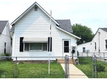 Charming white single Gathering home with a well-maintained lawn and an inviting front entrance at 408 W 4Th St, Anderson, IN 46016