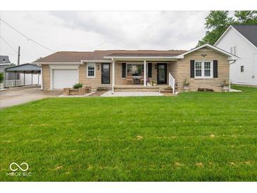 Charming single-story home with a covered front porch and well-maintained lawn at 524 W Campbell St, Edinburgh, IN 46124