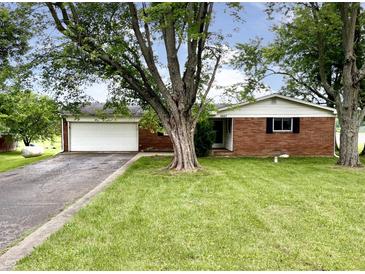 Charming brick home with an attached garage and a well-maintained front yard at 5667 Broyles Rd, Avon, IN 46123