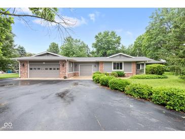 Charming single-story home featuring a multi-car garage, brick accents, and well-maintained landscaping at 6575 E 171St St, Noblesville, IN 46062