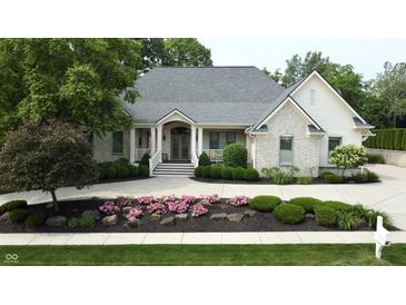 Charming home with stone accents, a well-manicured lawn, and inviting curb appeal at 7106 Royal Oakland Dr, Indianapolis, IN 46236