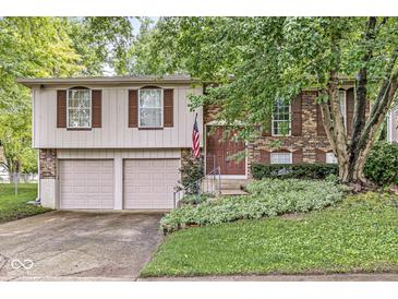 Charming two-story home featuring brick and siding, complemented by a well-manicured lawn and inviting curb appeal at 7616 E Concord Ln, Fishers, IN 46038
