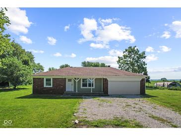 Charming single-story home featuring a brick accent, covered entry, and an attached garage on a sunny, tree-lined lot at 10727 N Shupe Rd, Monrovia, IN 46157