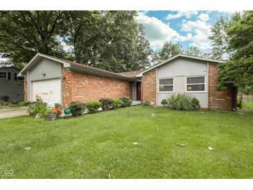Charming brick home with a well-manicured lawn and flower beds at 13 Fairlane Dr, Brownsburg, IN 46112