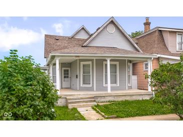 Charming, two-story home with welcoming front porch and well-maintained landscaping at 1310 California St, Columbus, IN 47201
