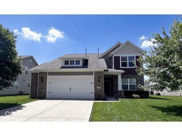 Charming two-story home with a brick and siding exterior, attached two-car garage, and well-manicured lawn at 13992 Wynngate Ln, Fishers, IN 46038