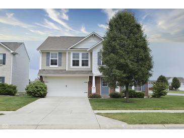 Charming two-story home featuring neutral siding, an attached garage, and a well-manicured front lawn at 2615 Pumpkin Patch Ln, Indianapolis, IN 46229