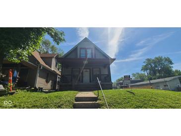 Charming two-story home with a covered porch and steps leading to the entrance at 435 N Rural Ne St, Indianapolis, IN 46201