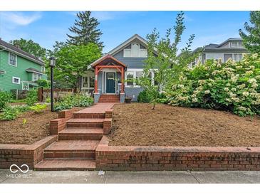 Charming two-story home featuring well-maintained landscaping and an inviting brick entryway at 4356 N College Ave, Indianapolis, IN 46205
