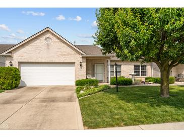 Charming single-story brick home with a well-manicured lawn and attached two-car garage at 564 Parkhurst Ct, Greenwood, IN 46142