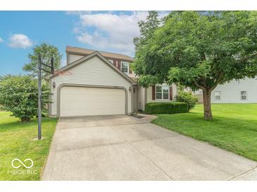 Two-story home with a two-car garage, basketball hoop, and well-maintained landscaping at 6937 Thousand Oaks Dr, Indianapolis, IN 46214