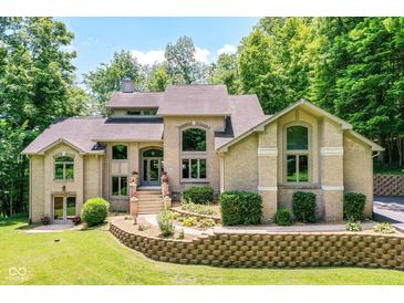 Stunning two-story brick home with manicured landscaping and a welcoming front entrance at 8004 Lafayette Rd, Indianapolis, IN 46278