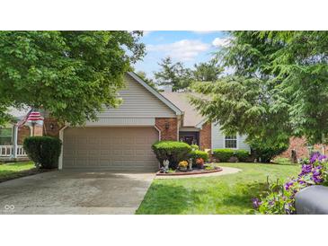 Charming single Gathering home with mature landscaping and a two car attached garage at 1067 Acadia Ct, Indianapolis, IN 46217