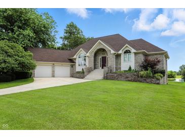 Charming brick home featuring a well-manicured lawn and a two-car garage with beautiful shrubbery at 1326 Pebble Brook Dr, Noblesville, IN 46062