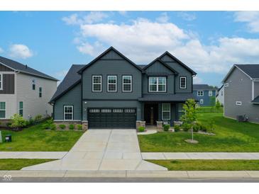 Beautiful two-story home featuring dark siding, a well-maintained lawn, and an attached two-car garage at 15192 Montfort Dr, Noblesville, IN 46062