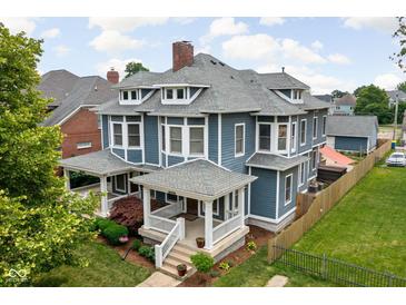 Impressive two-story home featuring a classic design, landscaped yard, and inviting front porch at 1531 N College Ave, Indianapolis, IN 46202