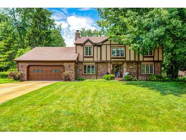 Charming two-story home with a well-manicured lawn and a classic Tudor-style facade at 1660 Obara Ct, Carmel, IN 46033