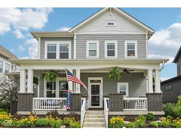Charming two-story home featuring a welcoming front porch with beautiful landscaping at 2105 Granville Dr, Westfield, IN 46074