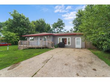 Charming one-story home with a long drive and a cozy front deck at 2610 Caroline Ave, Indianapolis, IN 46218