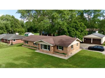 Charming brick home with a well-maintained lawn and detached garage at 771 Doran Ave, Shelbyville, IN 46176