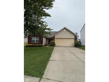 Charming single-story home with a well-manicured lawn and a two-car attached garage, featuring brick and siding accents at 8113 Maple Stream Ln, Indianapolis, IN 46217